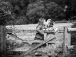 kissing on a fence