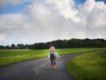 Child running down road