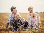 family sitting in field