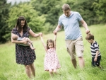 family walking through long grass