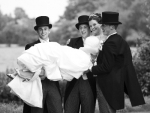 Groomsmen carrying bride