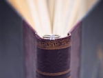 Wedding ring on old book