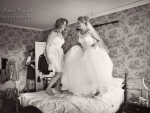 Bride jumping on bed