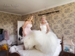 Bride jumping on bed